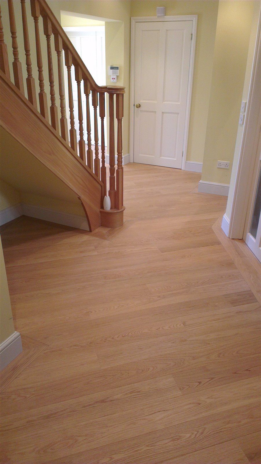 Prefinished engineered oak hallway with a matching perimeter border by Select Line