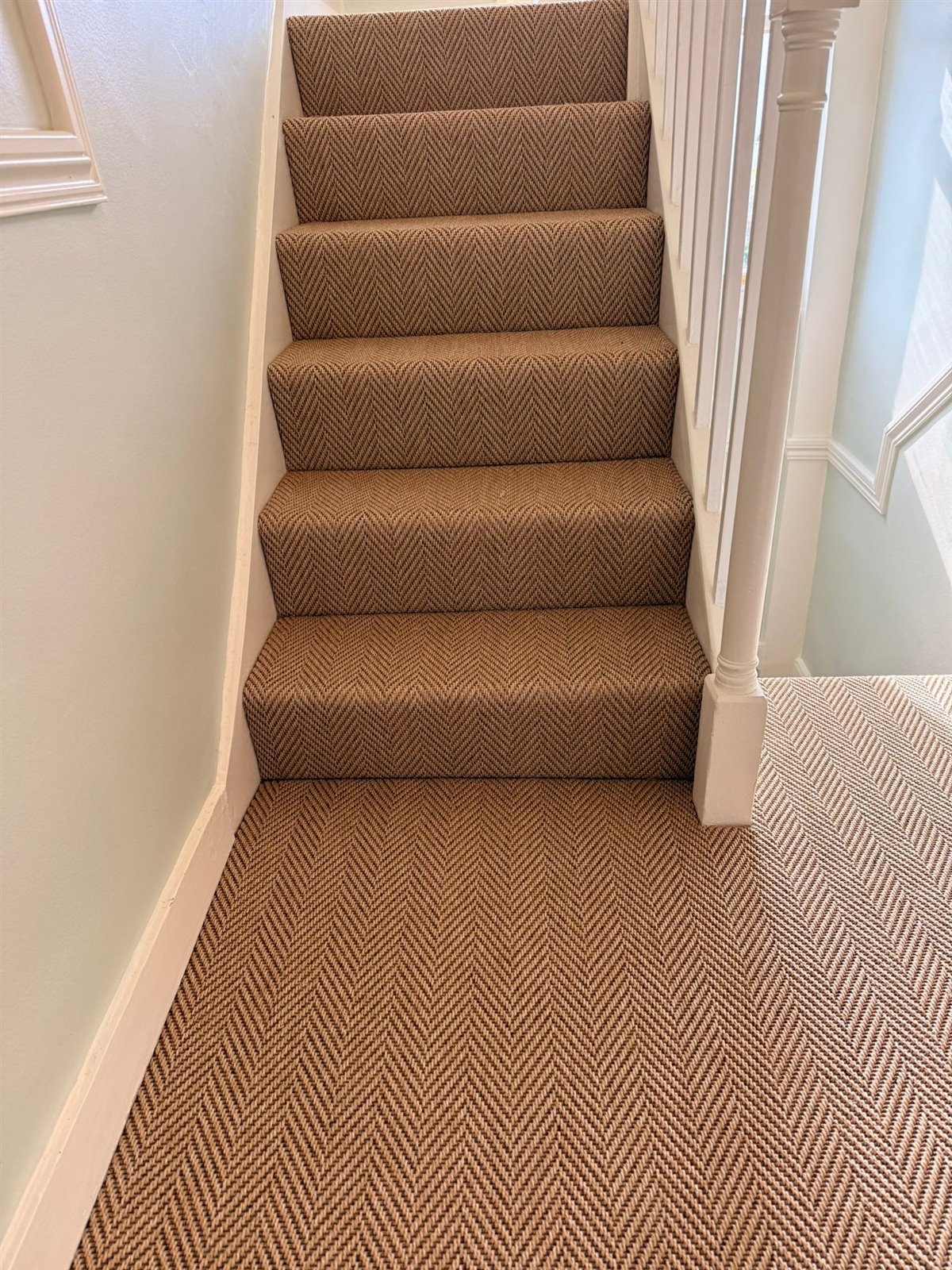 Continuous herringbone pattern across landings and stairs by Select Line craftsmen